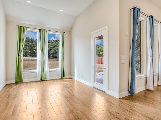 entryway featuring light hardwood / wood-style floors and lofted ceiling