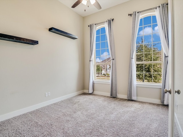 carpeted spare room with ceiling fan