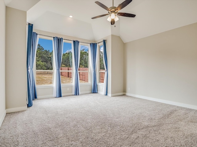 unfurnished room featuring vaulted ceiling, carpet flooring, and ceiling fan