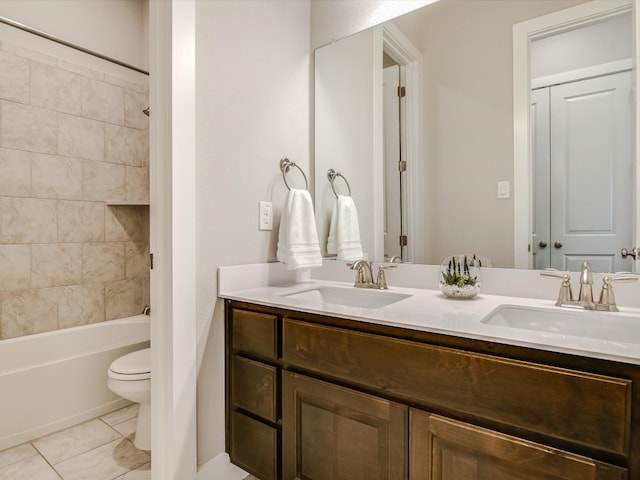 full bathroom with toilet, tiled shower / bath combo, vanity, and tile patterned flooring