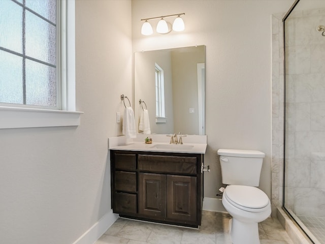 bathroom featuring toilet, vanity, and a shower with door