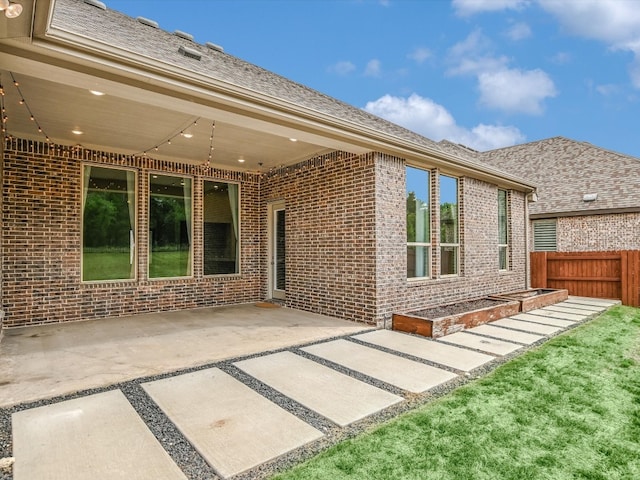 rear view of property featuring a patio area