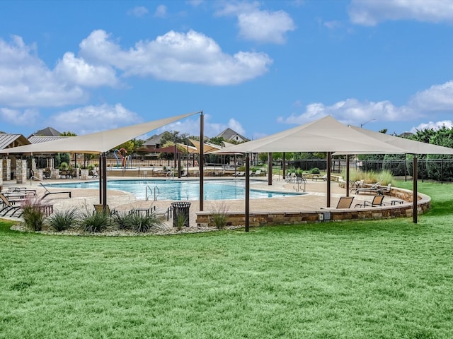 view of swimming pool with a yard and a patio area