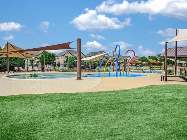 view of playground featuring a lawn and a community pool