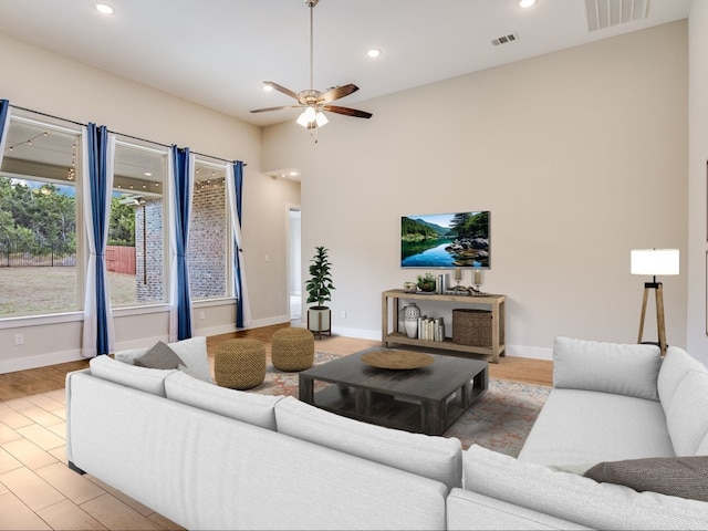 living room featuring ceiling fan and light hardwood / wood-style floors