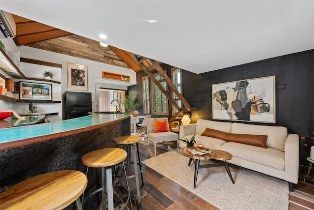 interior space featuring a wall mounted air conditioner, beamed ceiling, dark hardwood / wood-style floors, and indoor wet bar