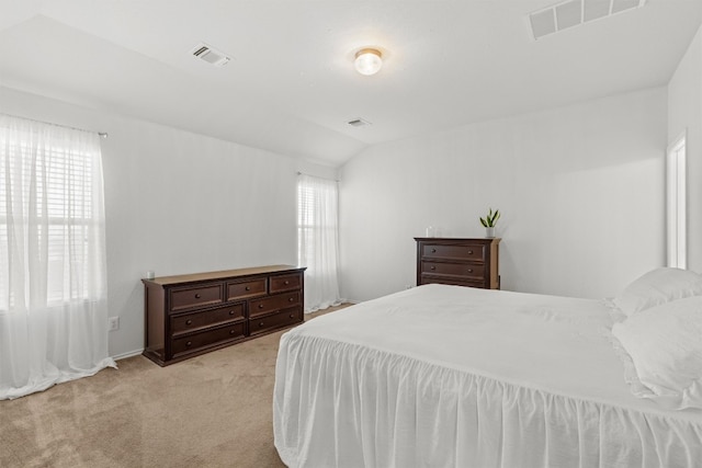 carpeted bedroom with vaulted ceiling