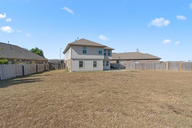 back of property featuring a yard