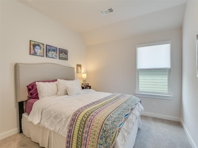 bedroom with light colored carpet and lofted ceiling