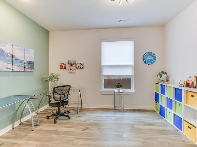 office space with light hardwood / wood-style flooring