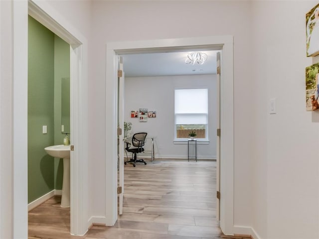 hall with light hardwood / wood-style floors