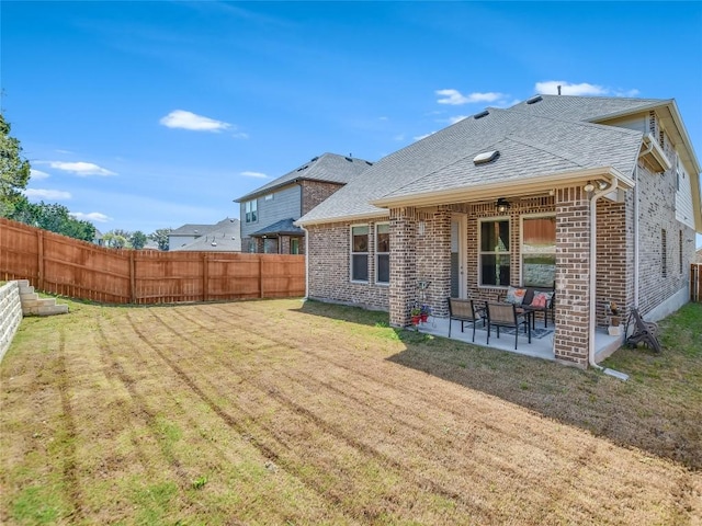 rear view of property with a patio area and a yard