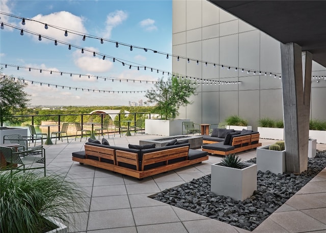 view of patio featuring an outdoor living space with a fire pit