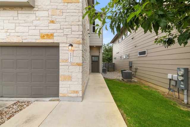 exterior space with a lawn and central AC unit