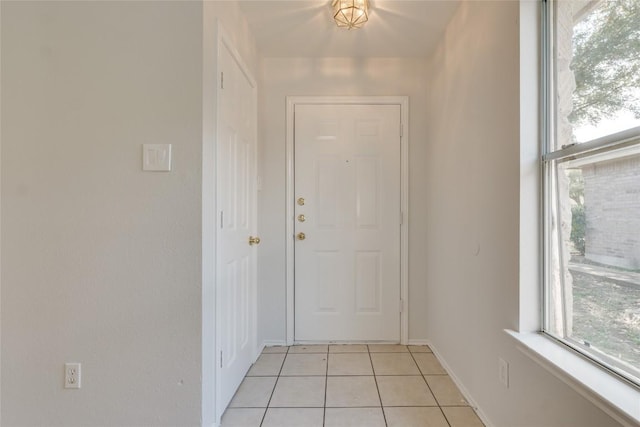 doorway with light tile patterned floors