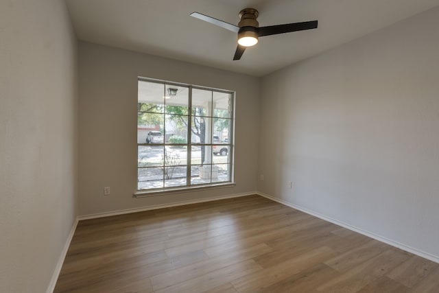 empty room with ceiling fan and light wood-type flooring