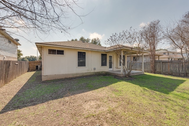 rear view of property with a patio area and a lawn