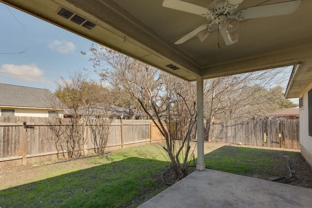 view of yard featuring a patio area and ceiling fan