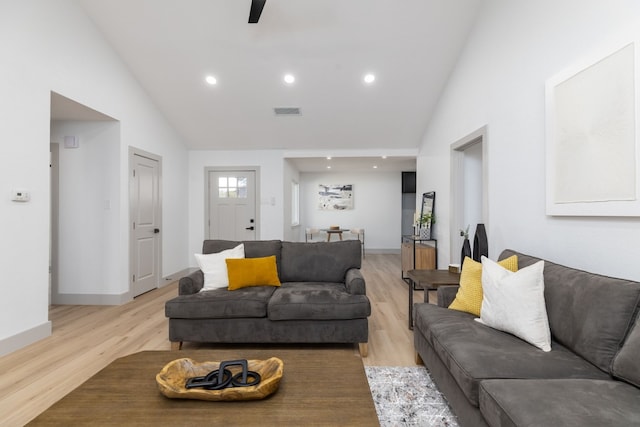 living room featuring light wood-type flooring, high vaulted ceiling, and ceiling fan