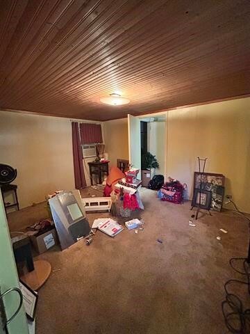 interior space with wood ceiling and carpet flooring