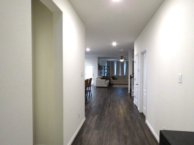 corridor with dark wood-type flooring