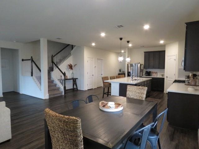 dining space featuring dark wood-type flooring and sink