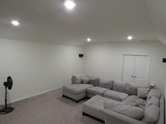 living room featuring light carpet and vaulted ceiling