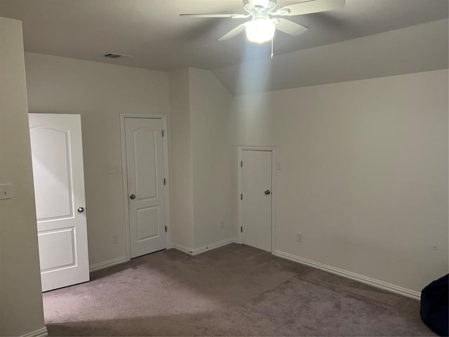 carpeted spare room with ceiling fan