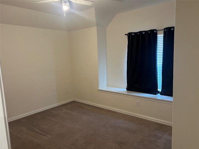 carpeted spare room featuring ceiling fan and lofted ceiling