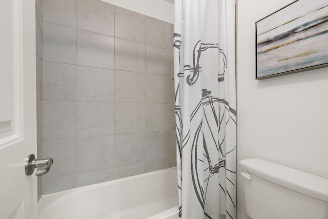 bathroom featuring toilet and shower / tub combo with curtain