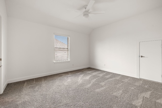 carpeted empty room with ceiling fan and vaulted ceiling