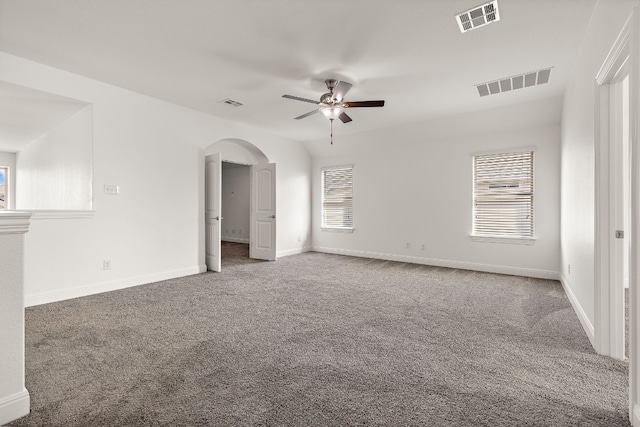 carpeted spare room featuring ceiling fan