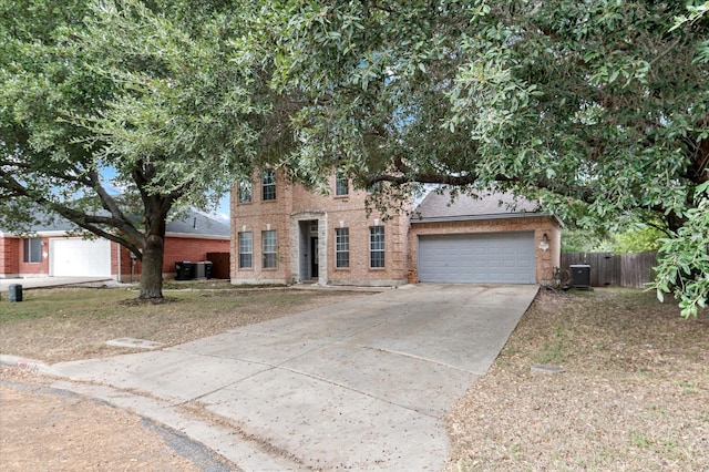 view of front of property featuring cooling unit and a garage