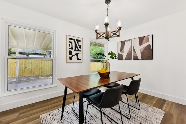 dining area featuring an inviting chandelier, hardwood / wood-style flooring, and a wealth of natural light