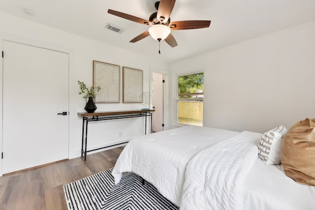 bedroom featuring wood-type flooring and ceiling fan