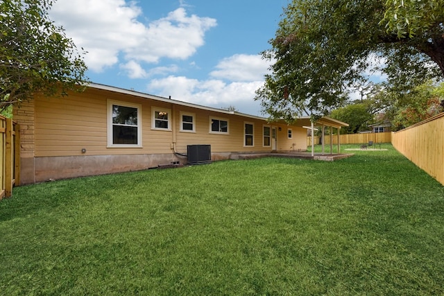 back of house featuring a patio area, central AC, and a yard