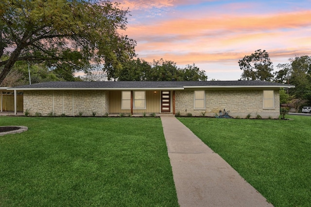 ranch-style house with a yard