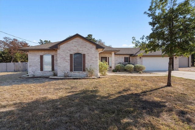 single story home featuring a front yard and a garage