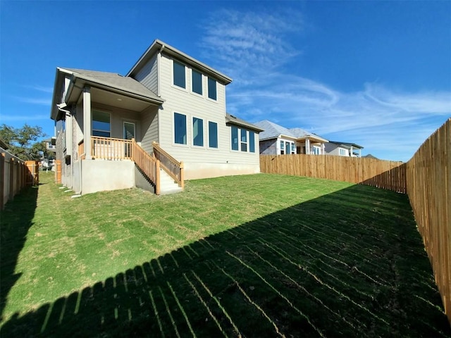 rear view of house with a lawn