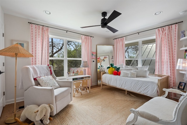 bedroom with light hardwood / wood-style floors and ceiling fan