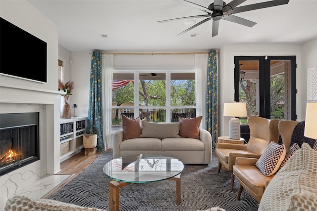 living room with hardwood / wood-style floors, a fireplace, and ceiling fan