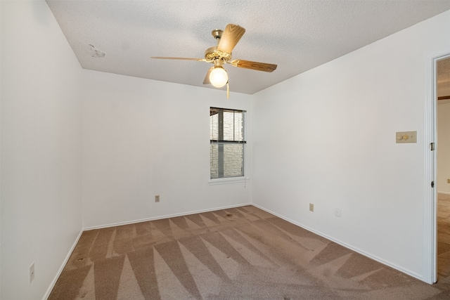 unfurnished room featuring a textured ceiling, carpet flooring, and ceiling fan