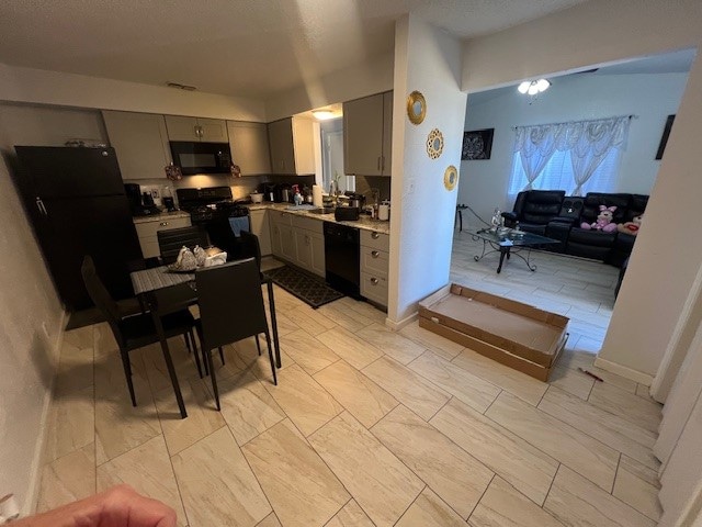 kitchen with gray cabinets, sink, and black appliances