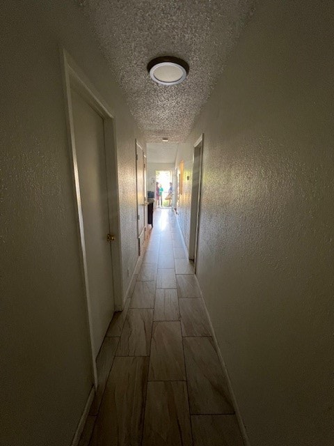 corridor with a textured ceiling