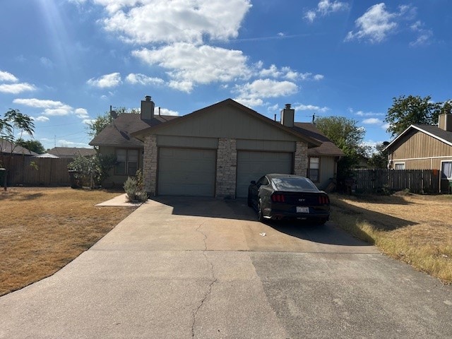 ranch-style house with a front yard and a garage