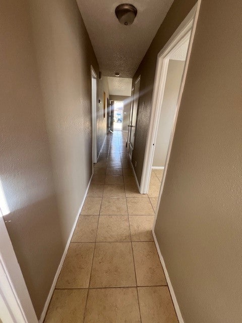 hall featuring light tile patterned floors