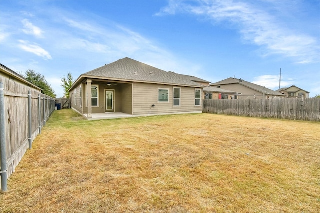 back of house featuring a yard and a patio area