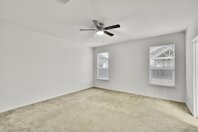 spare room with plenty of natural light and light colored carpet