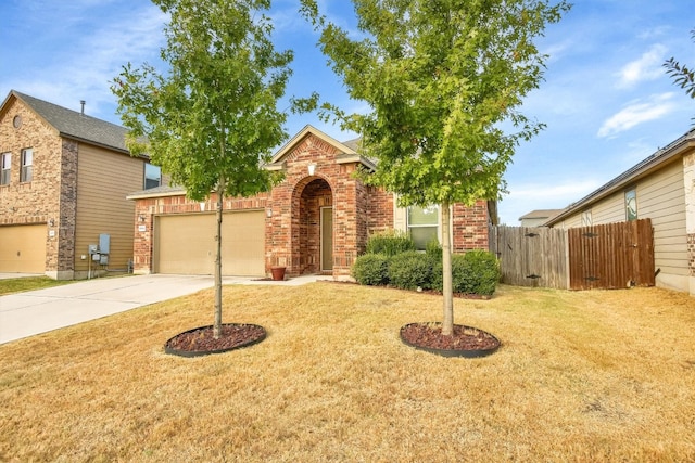 view of front of home with a front yard and a garage