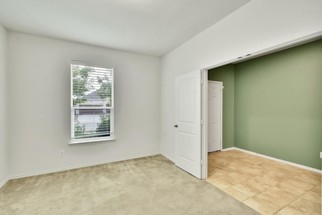 unfurnished room with light carpet